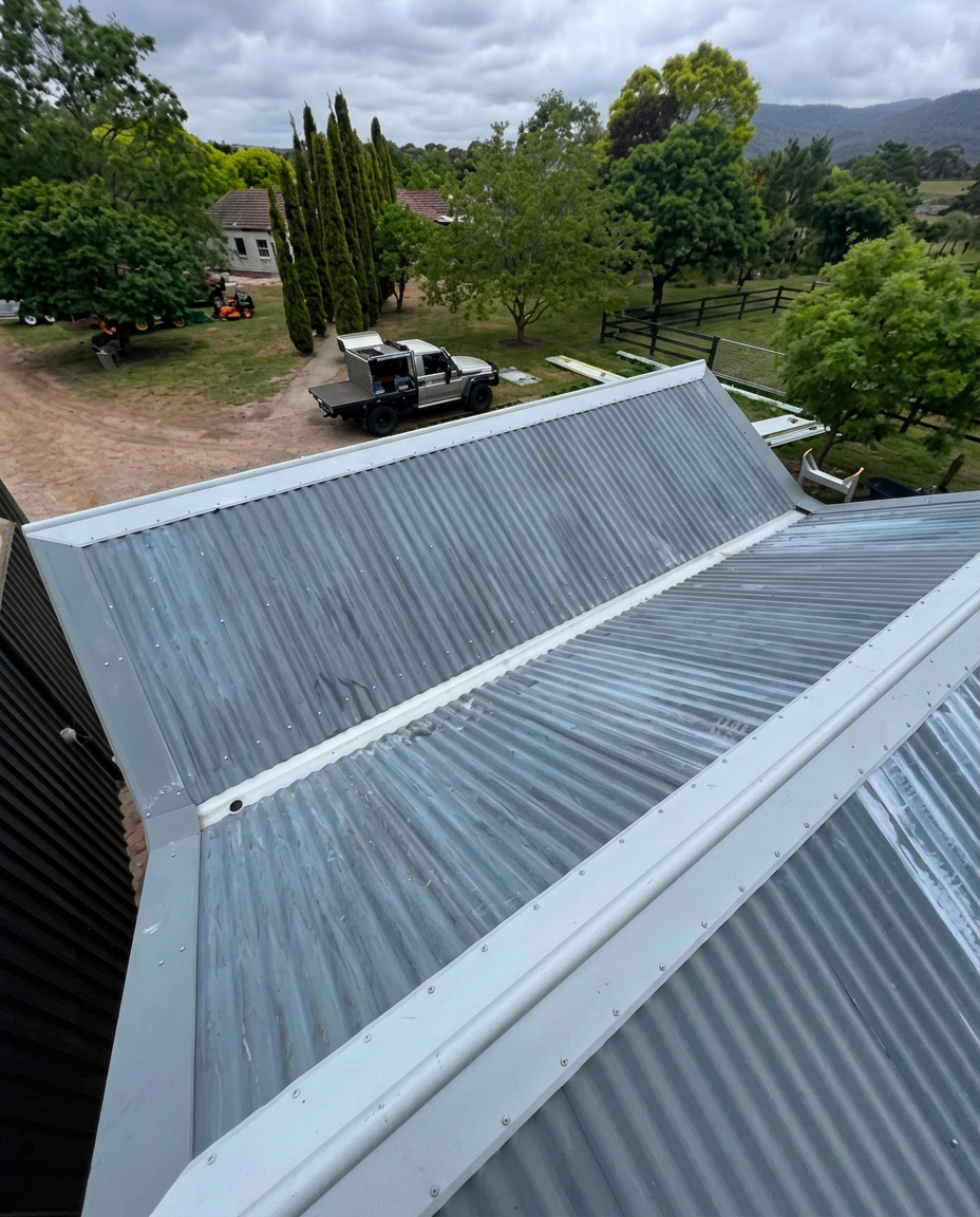Corrugated gabled roof with light ridge and junction flashings