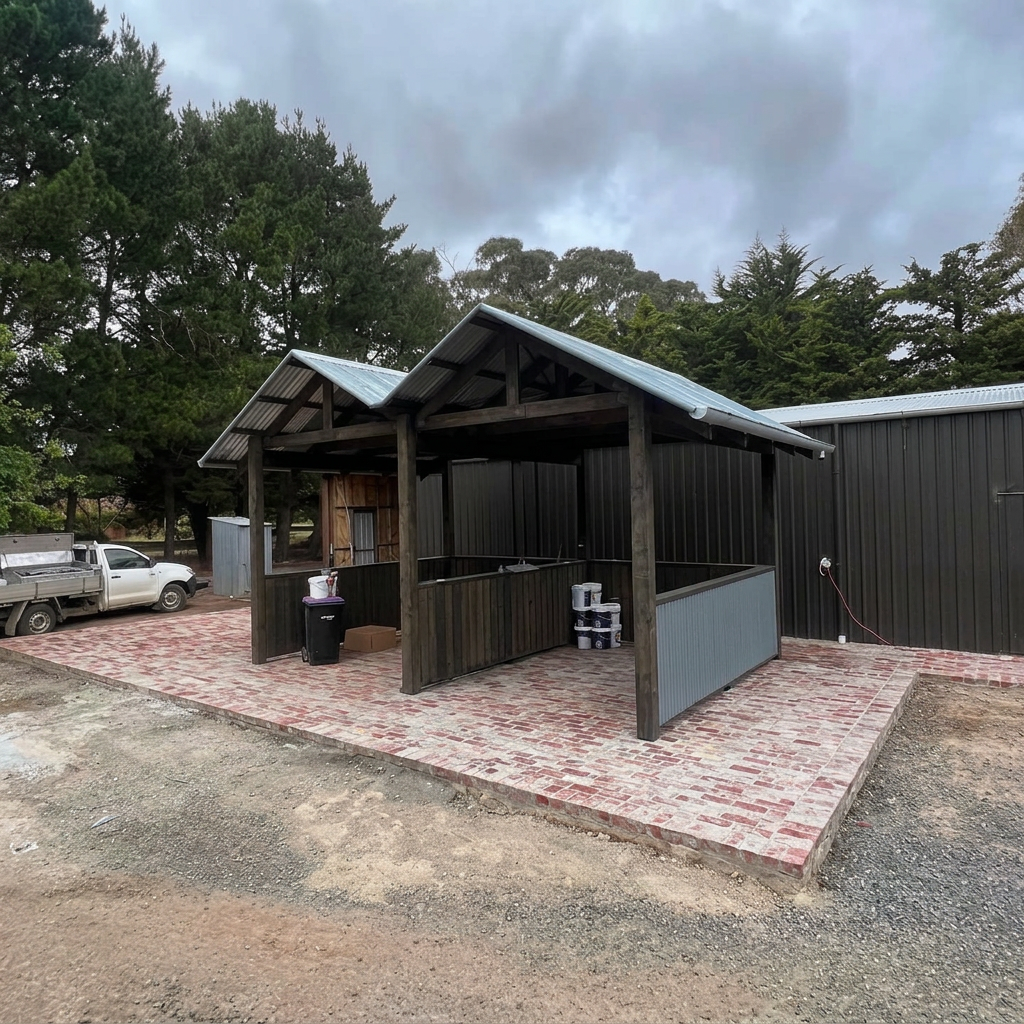 Twin metal gabled roofs over a timber-framed outdoor structure